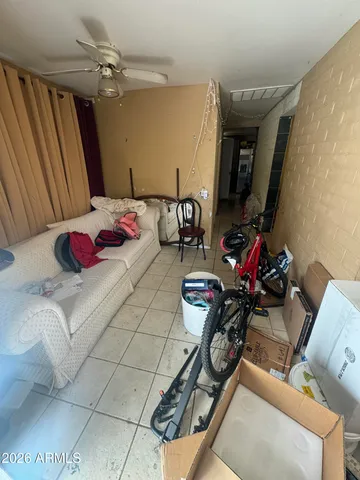 a room with stainless steel appliances kitchen island granite countertop a sink and wooden cabinets