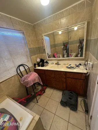 a room with stainless steel appliances kitchen island granite countertop a sink and wooden cabinets