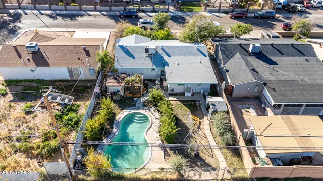 an aerial view of a house with a swimming pool and outdoor seating