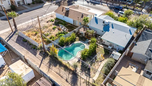 a aerial view of a house with a yard and potted plants