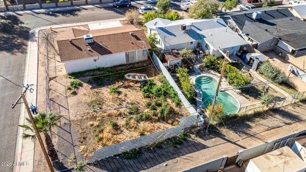 an aerial view of a house with a yard and trees