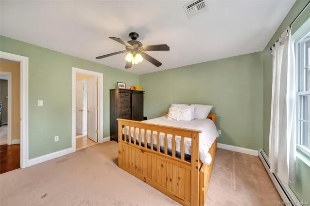 a bedroom with bed and wooden floor