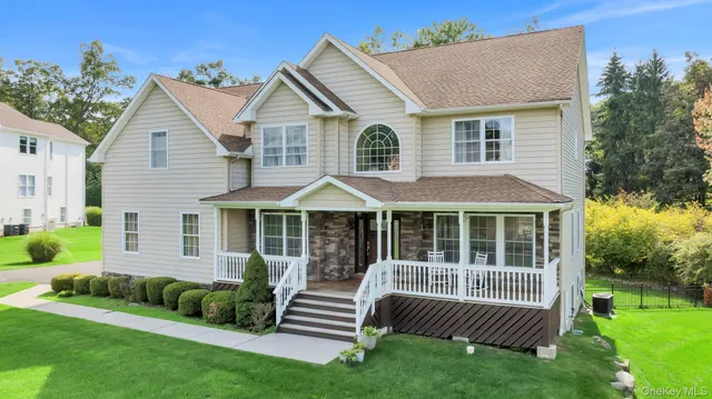 a view of a house with a yard and deck
