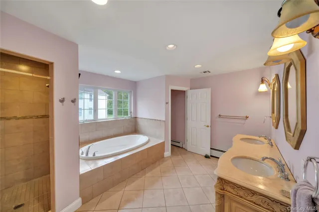 a bathroom with a tub sink and glass door