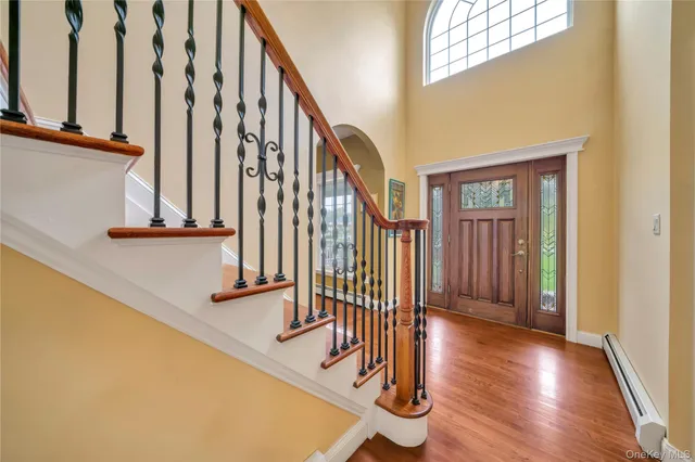 a view of an entryway with wooden floor and door