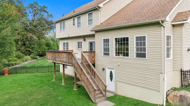 a front view of a house with a yard and trees