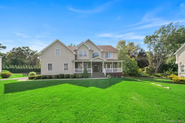 a front view of house with yard and green space