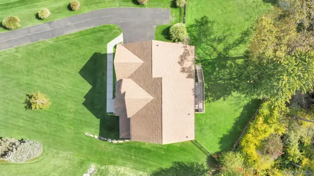 a view of a lush green forest with houses and lake view