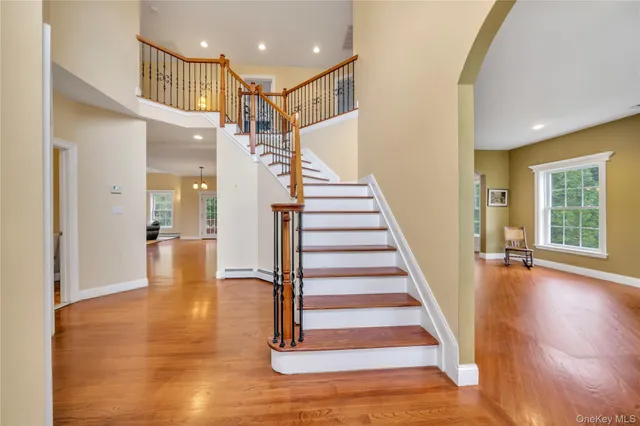 a view of entryway and hall with wooden floor