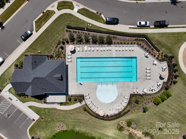 an aerial view of a house with a swimming pool