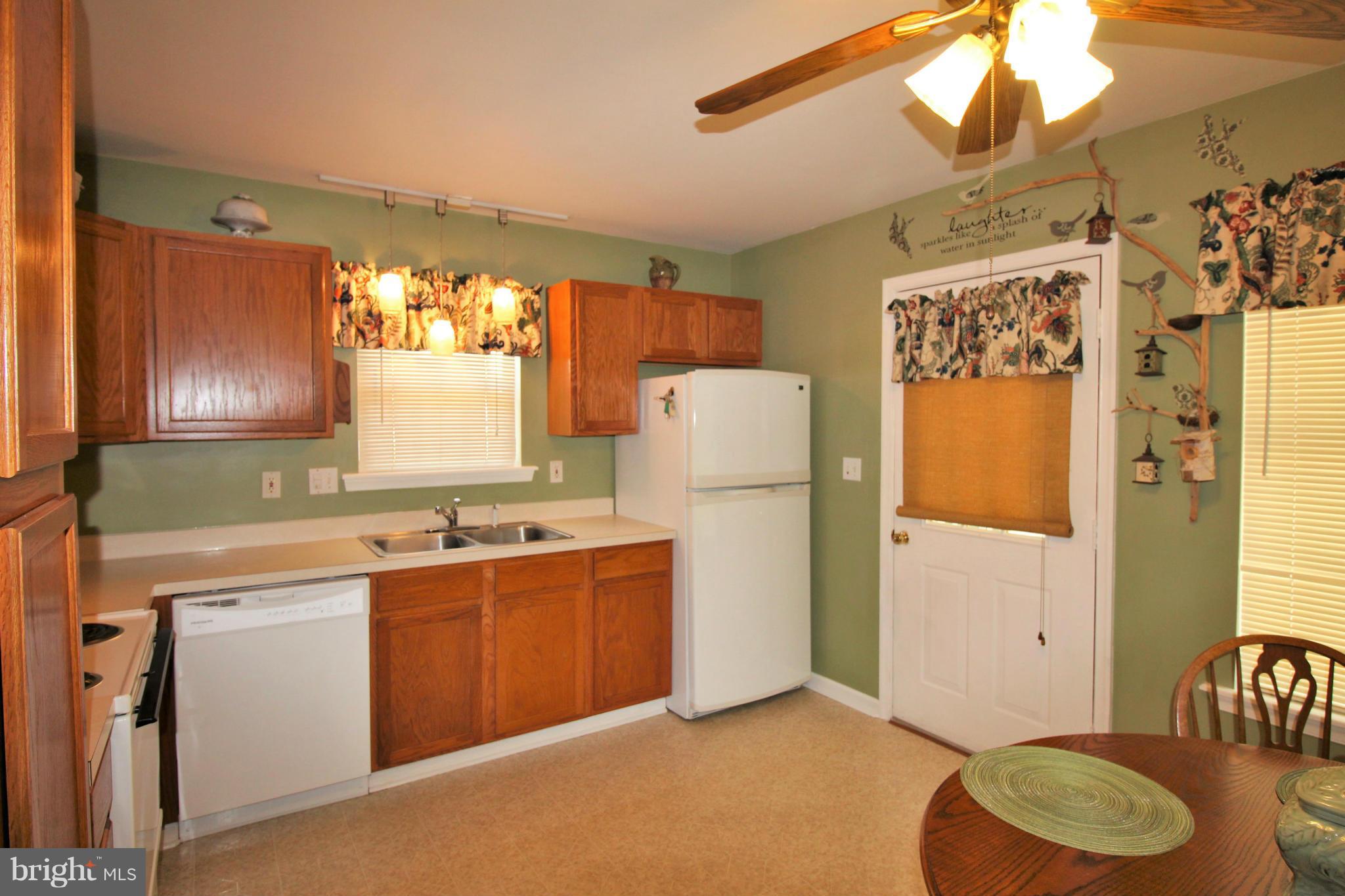 246 Windjammer Road Ocean Pines, MD 21811 - Photo 12 of 30 a kitchen that has a sink a refrigerator and window