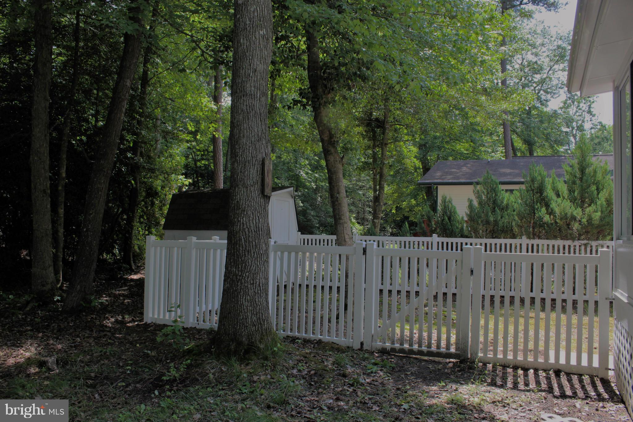 246 Windjammer Road Ocean Pines, MD 21811 - Photo 30 of 30 a wooden fence with trees in the background
