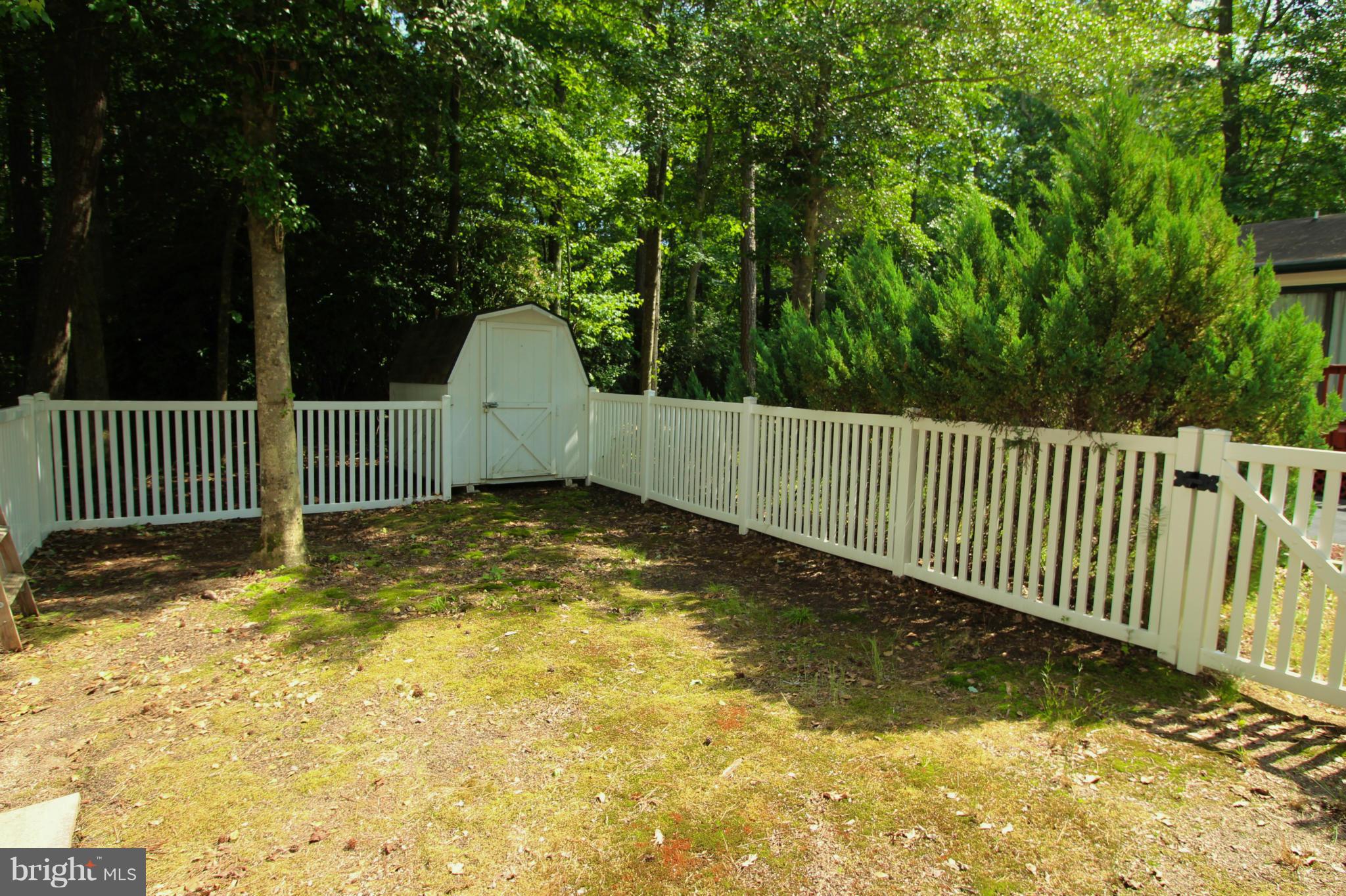 246 Windjammer Road Ocean Pines, MD 21811 - Photo 8 of 30 a view of a garden with a small cabin