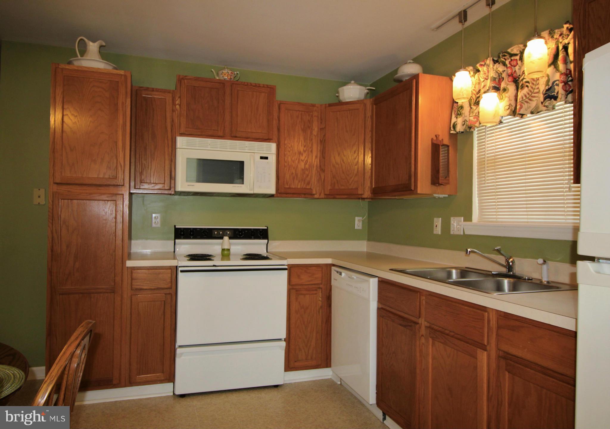 246 Windjammer Road Ocean Pines, MD 21811 - Photo 10 of 30 a kitchen with stainless steel appliances granite countertop a sink stove and refrigerator