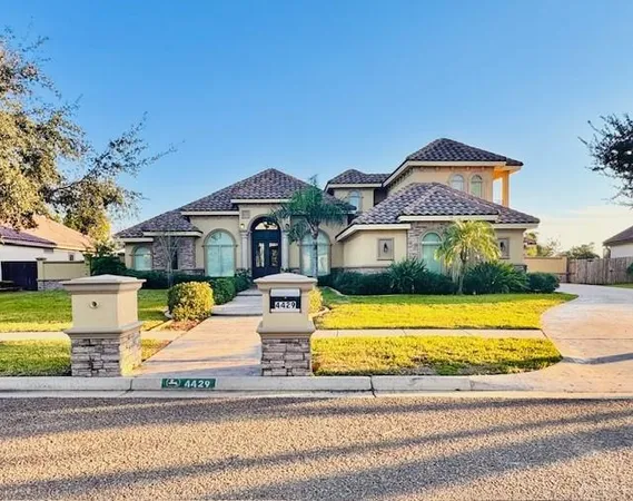 a front view of a house with a garden