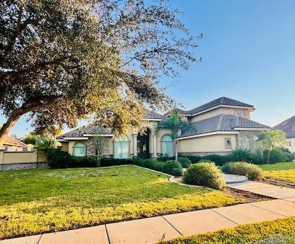 a front view of a house with a garden