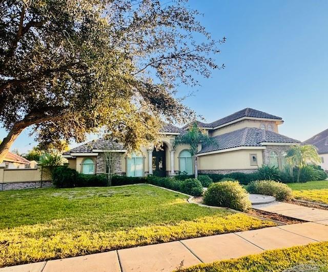 4429 Water's Edge Harlingen, TX 78552 - Photo 2 of 8 a front view of a house with a garden