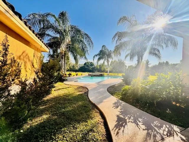 a view of swimming pool with sitting area