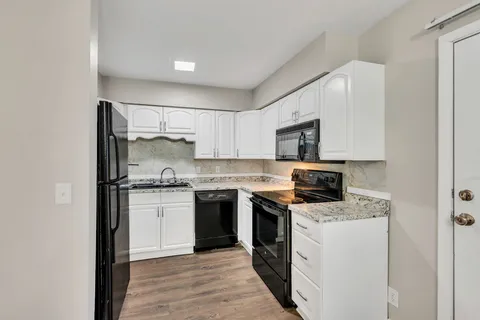 a kitchen with a stove sink and refrigerator
