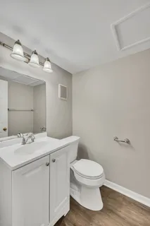 a bathroom with a toilet sink and mirror