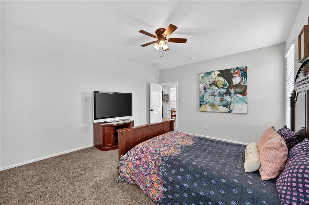 9604 Cherryville Road Fort Worth, TX 76108 - Photo 18 of 40 Carpeted room featuring light gray wall paint, a ceiling fan with light fixture, and a white door with a black handle