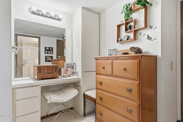 a living room with furniture and a dresser