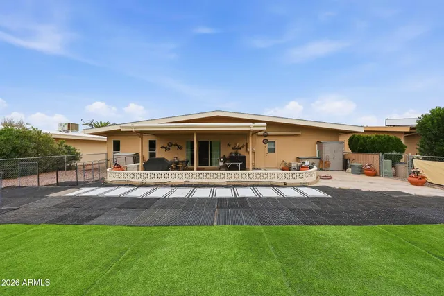 a front view of house with yard seating and green space