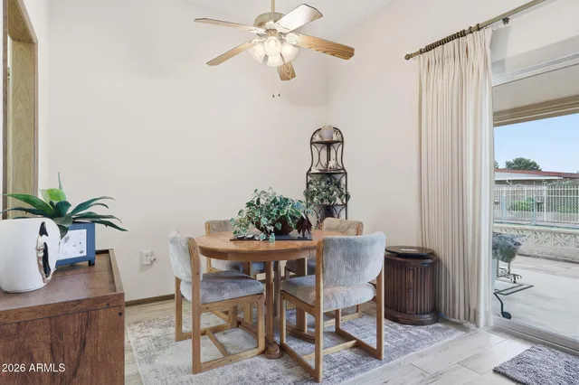 a view of a dining room with furniture and a potted plant