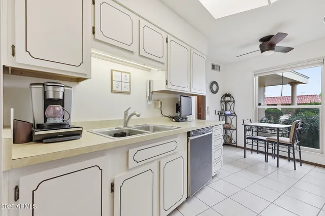 a kitchen with stainless steel appliances granite countertop a sink and cabinets