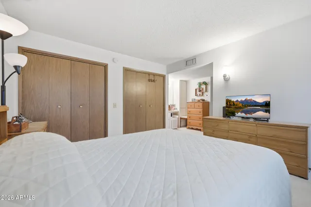 a bedroom with a bed and a flat screen tv