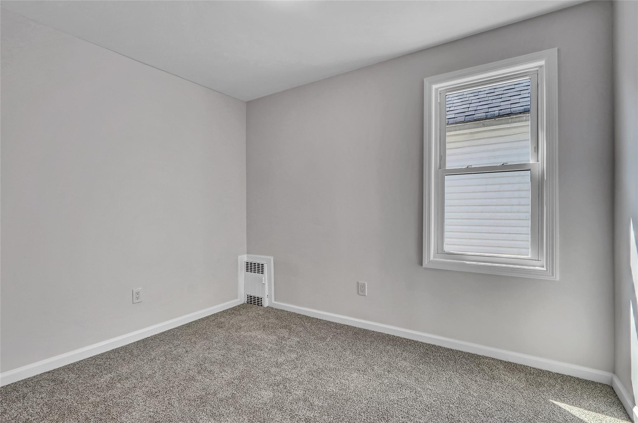 111-32 116th Street Queens, NY 11420 - Photo 11 of 18 an empty room with a window