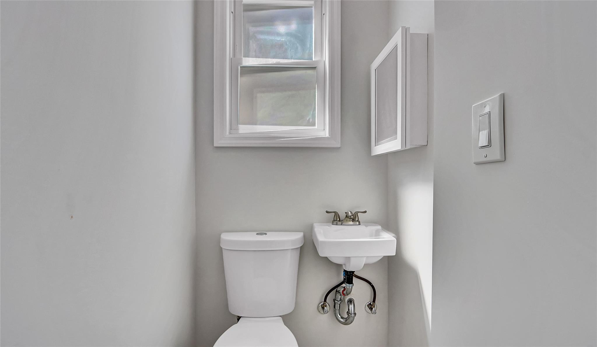 111-32 116th Street Queens, NY 11420 - Photo 12 of 18 a bathroom with a sink toilet and a mirror