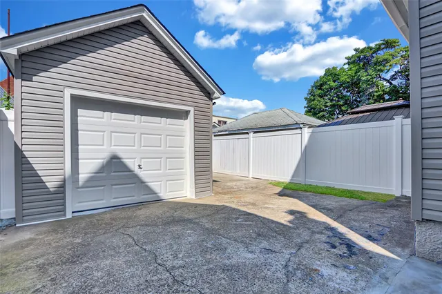 a view of a house with a yard and garage