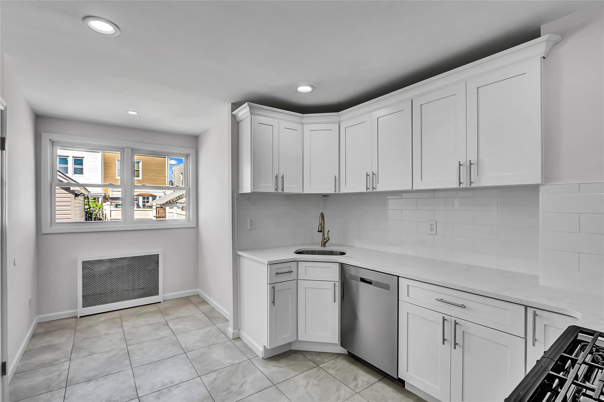 111-32 116th Street Queens, NY 11420 - Photo 8 of 18 a kitchen with white cabinets and appliances