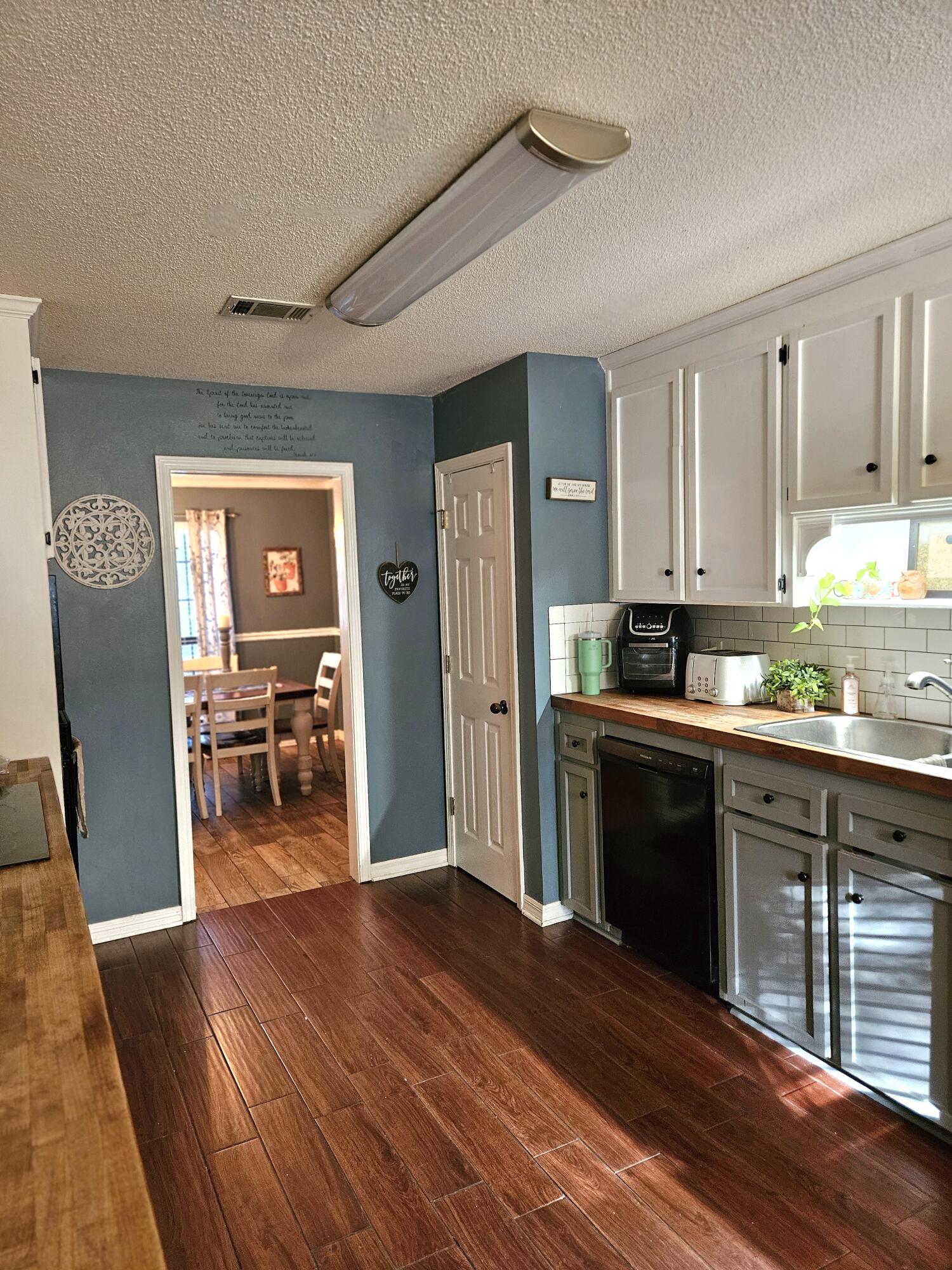 108 Mohawk Trail Crestview, FL 32536 - Photo 15 of 39 a kitchen with granite countertop wooden floors and refrigerator