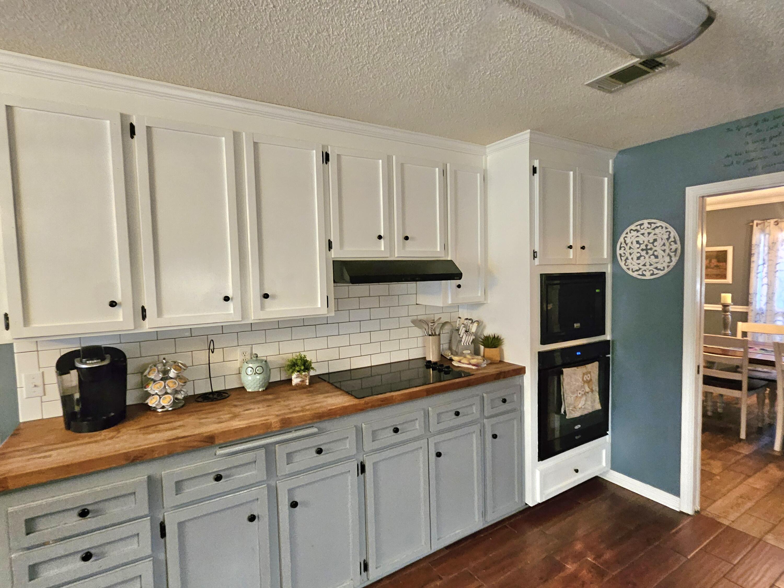108 Mohawk Trail Crestview, FL 32536 - Photo 16 of 39 a kitchen with stainless steel appliances granite countertop a sink a stove and cabinets