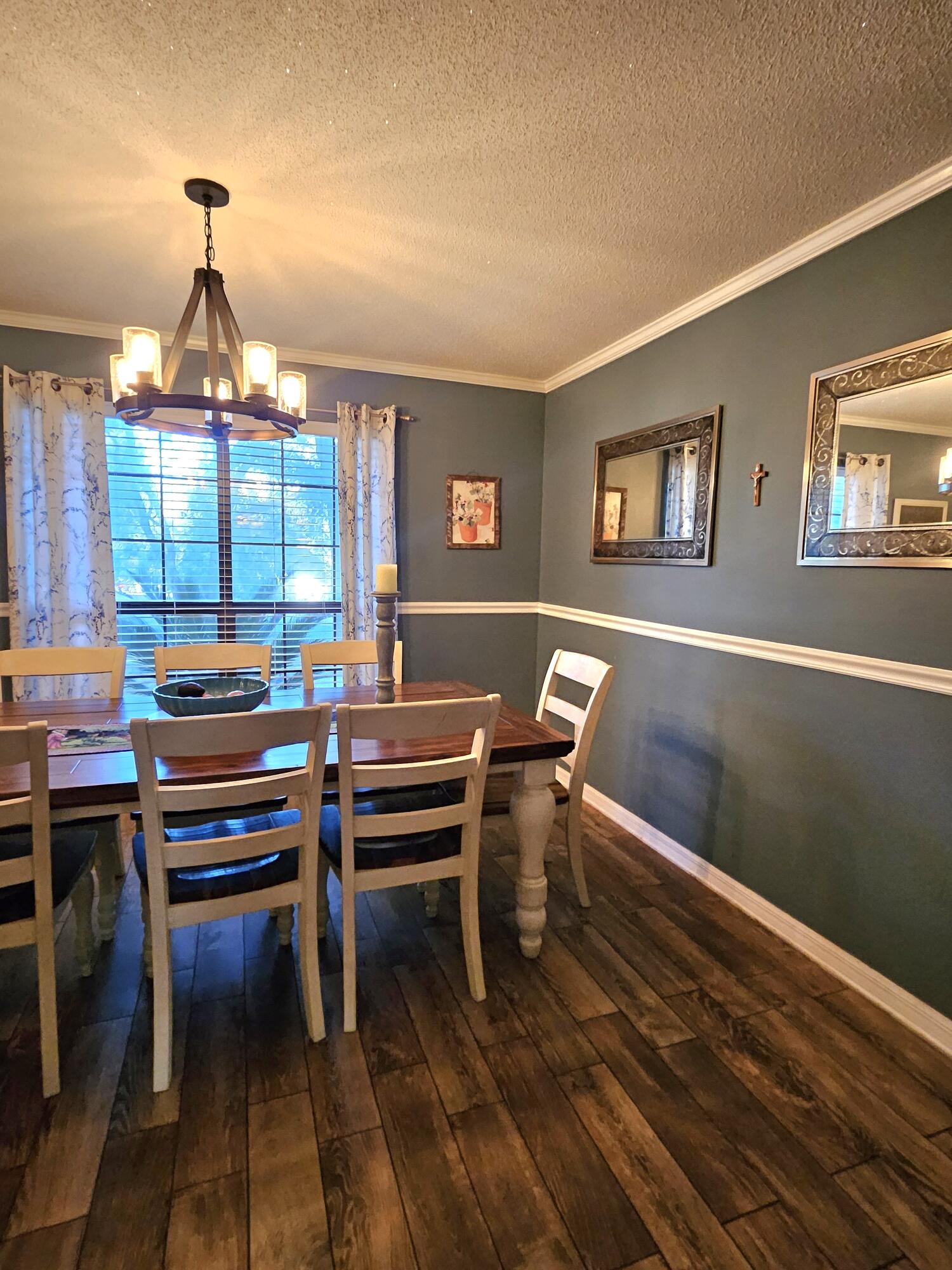 108 Mohawk Trail Crestview, FL 32536 - Photo 17 of 39 a dining room with a wooden table and chairs
