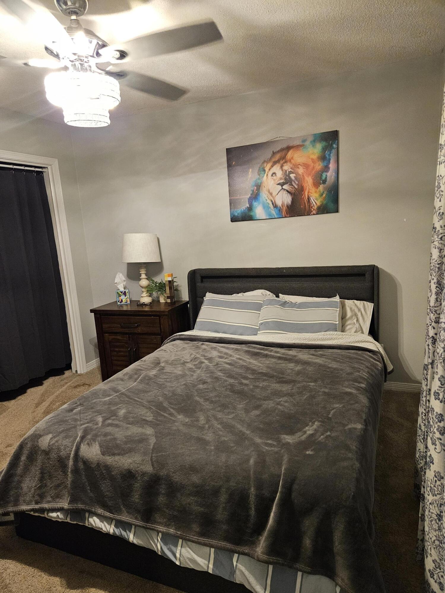 108 Mohawk Trail Crestview, FL 32536 - Photo 19 of 39 a bedroom with a bed and a chandelier