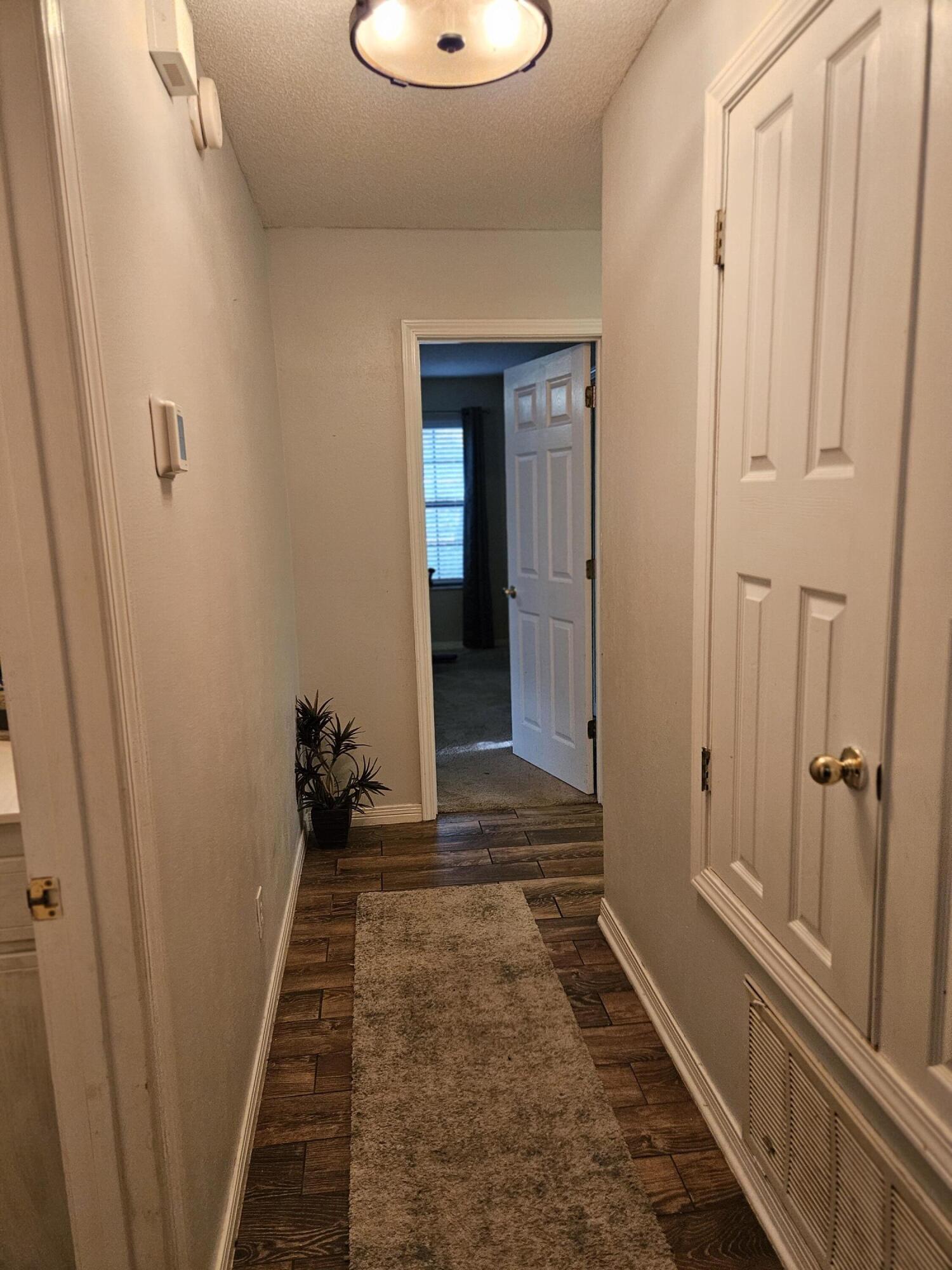 108 Mohawk Trail Crestview, FL 32536 - Photo 22 of 39 a view of a hallway with wooden floor and staircase