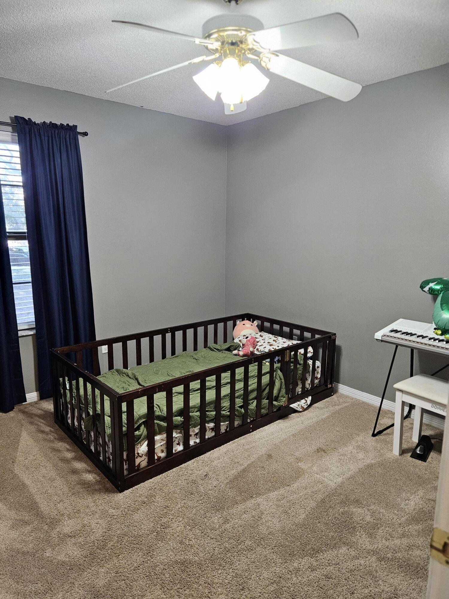 108 Mohawk Trail Crestview, FL 32536 - Photo 24 of 39 a bed sitting in a bedroom next to a window