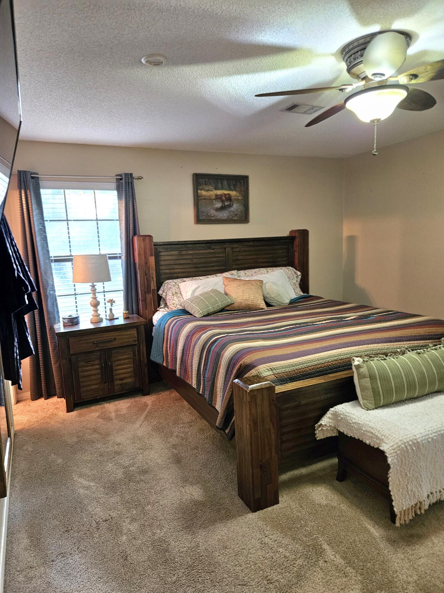 108 Mohawk Trail Crestview, FL 32536 - Photo 26 of 39 a bedroom with a bed and a chandelier