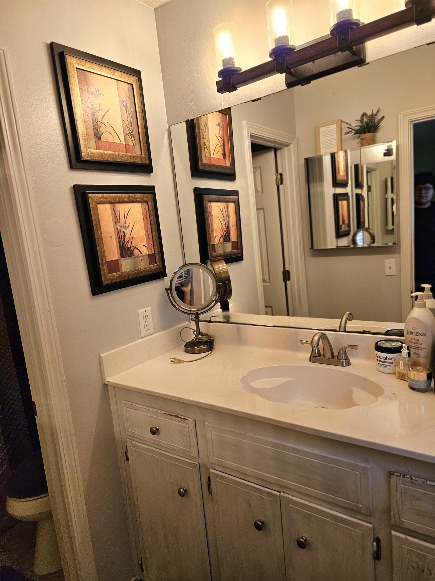 108 Mohawk Trail Crestview, FL 32536 - Photo 27 of 39 a bathroom with a sink mirror and vanity