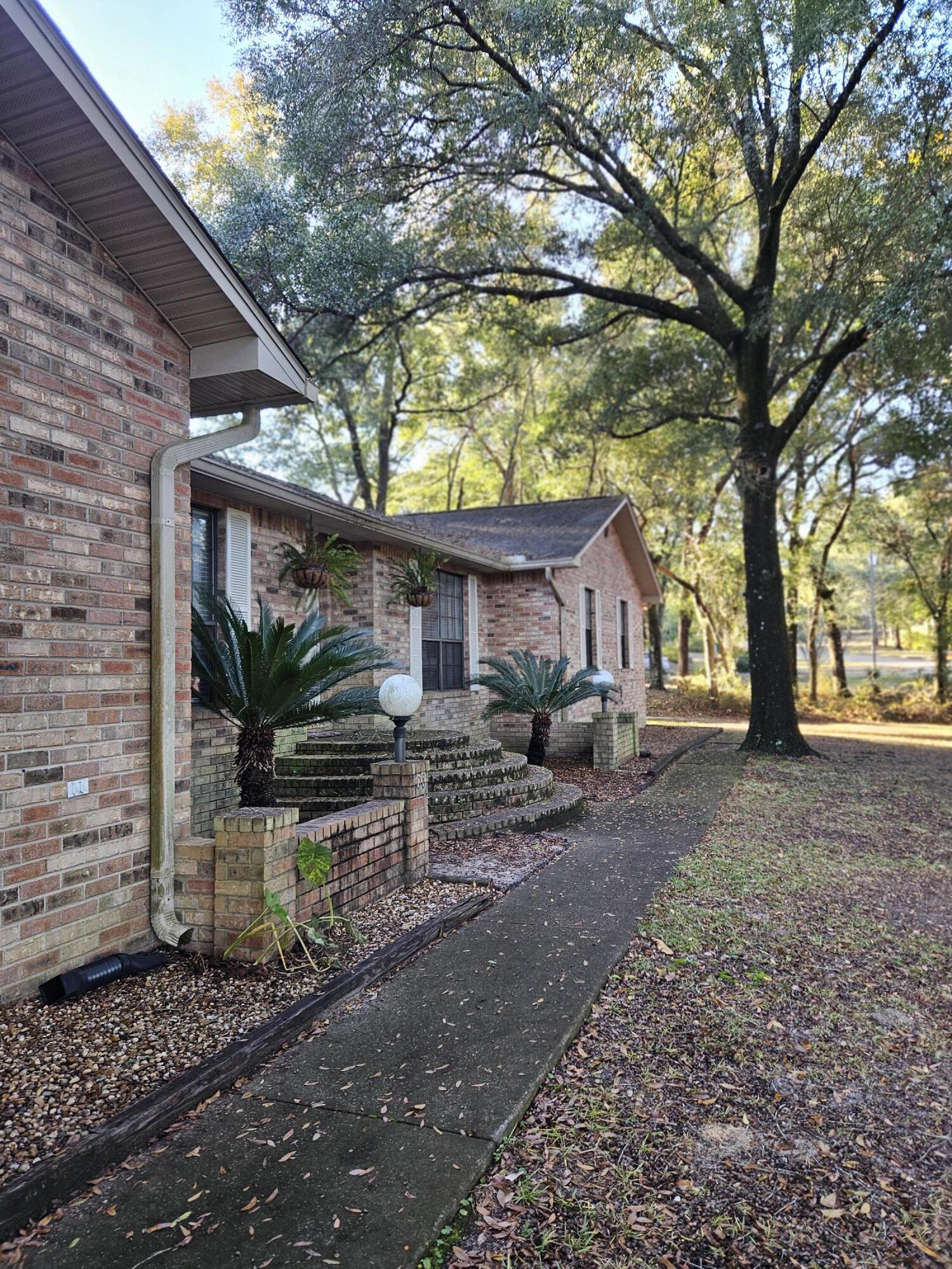 108 Mohawk Trail Crestview, FL 32536 - Photo 3 of 39 a view of a house with a yard and tree