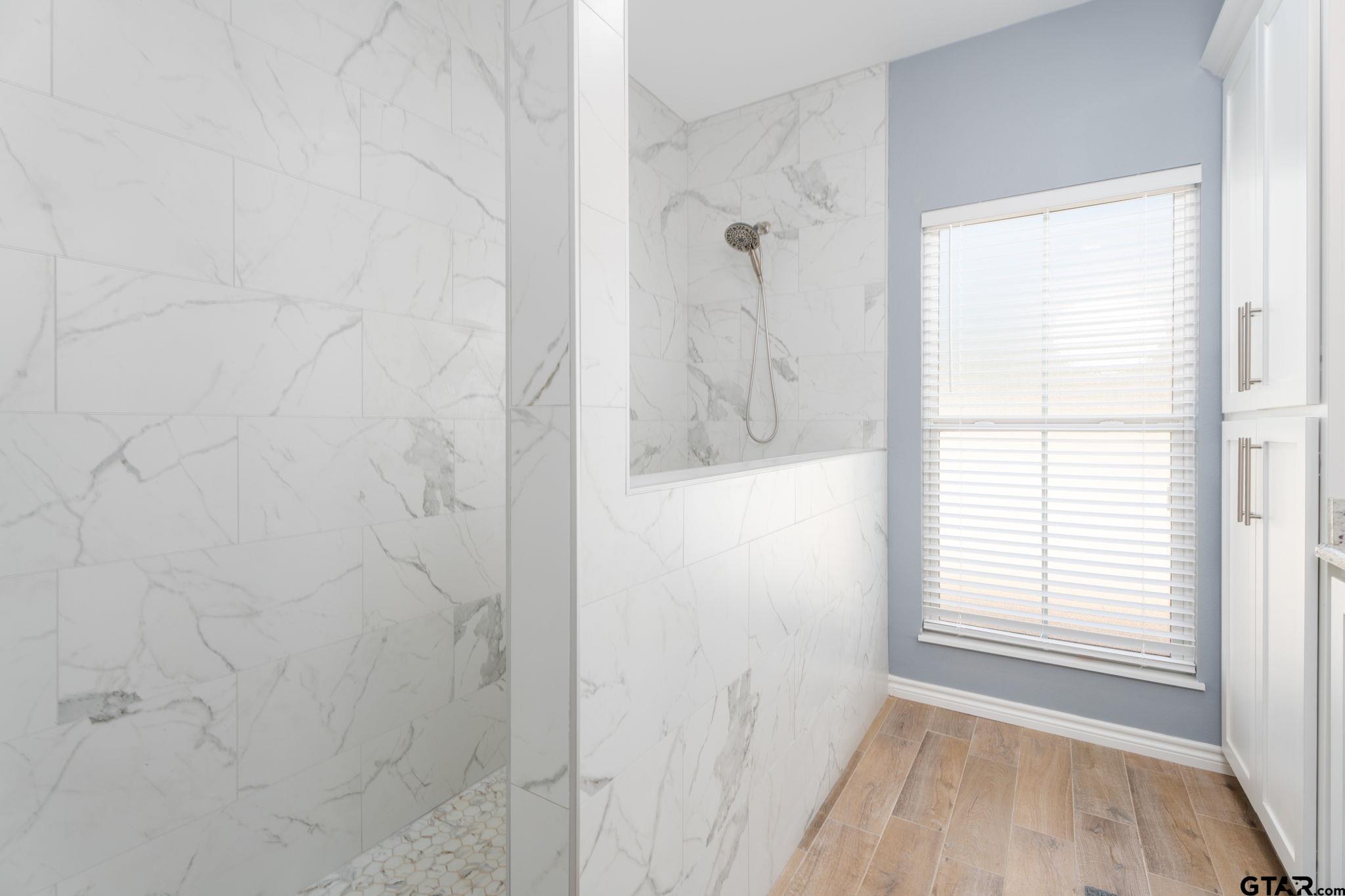 4356 Buie Road Diana, TX 75640 - Photo 13 of 29 a bathroom with a window and a shower