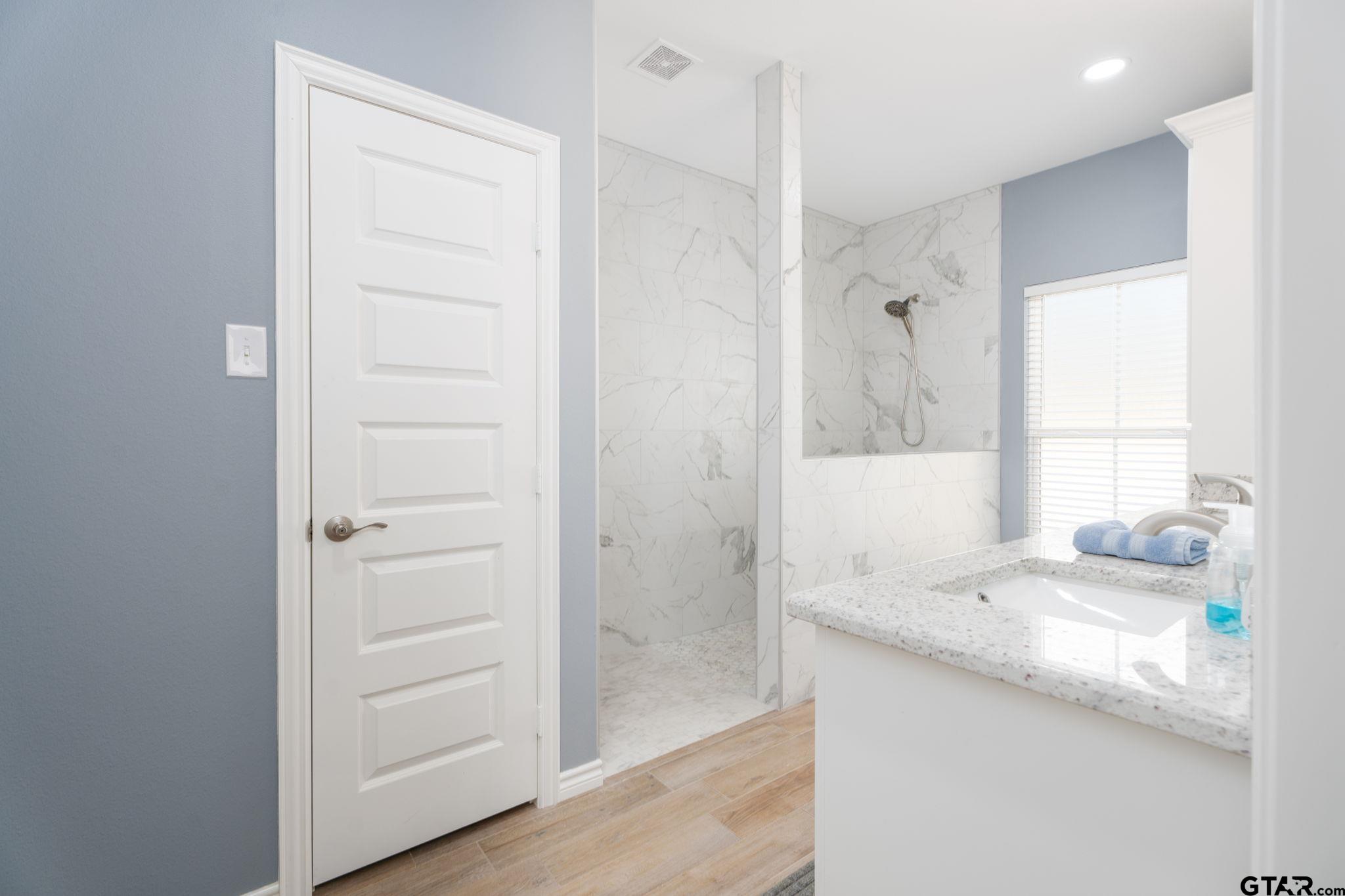 4356 Buie Road Diana, TX 75640 - Photo 14 of 29 a bathroom with a granite countertop sink and a mirror