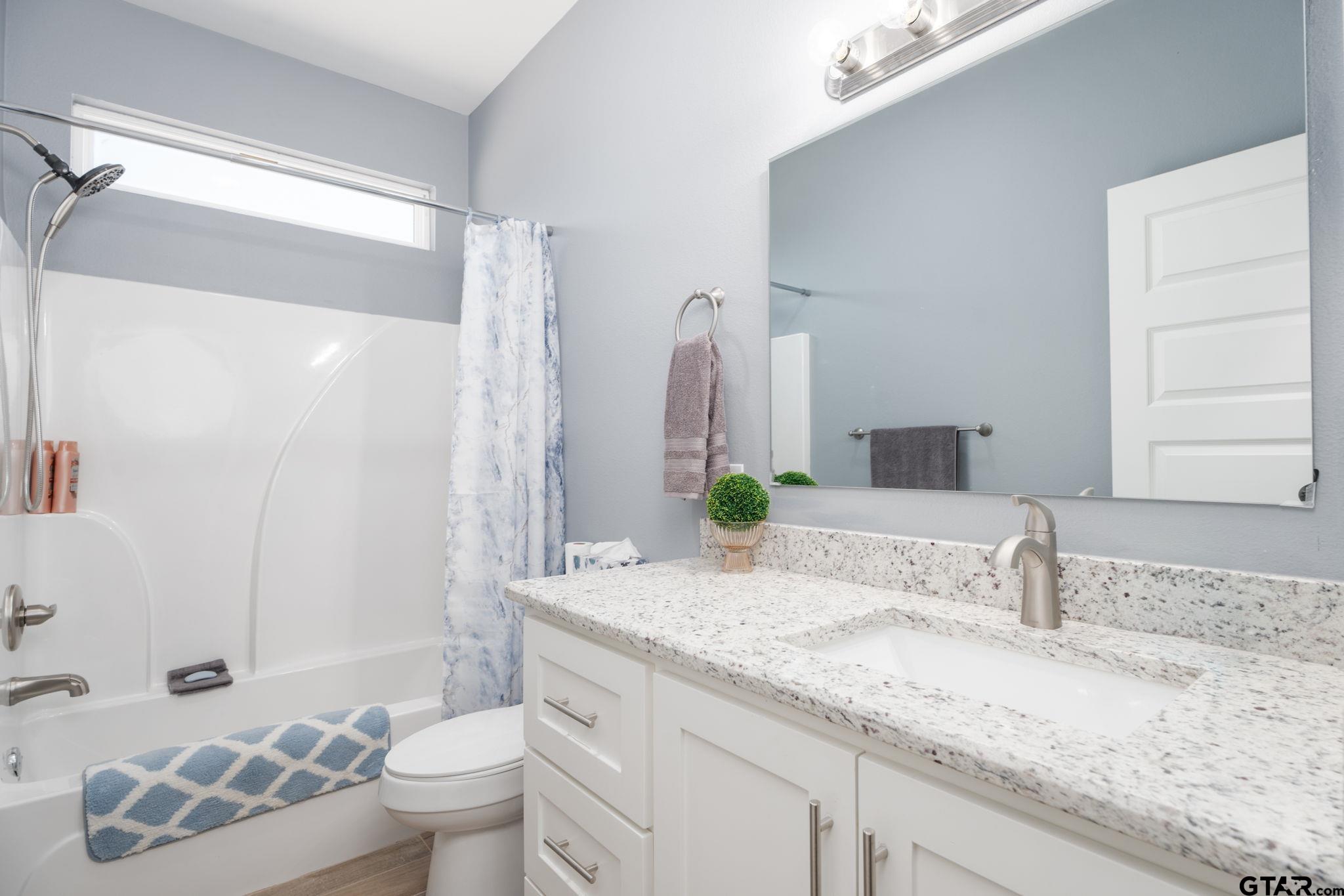 4356 Buie Road Diana, TX 75640 - Photo 17 of 29 a bathroom with a granite countertop sink and a mirror
