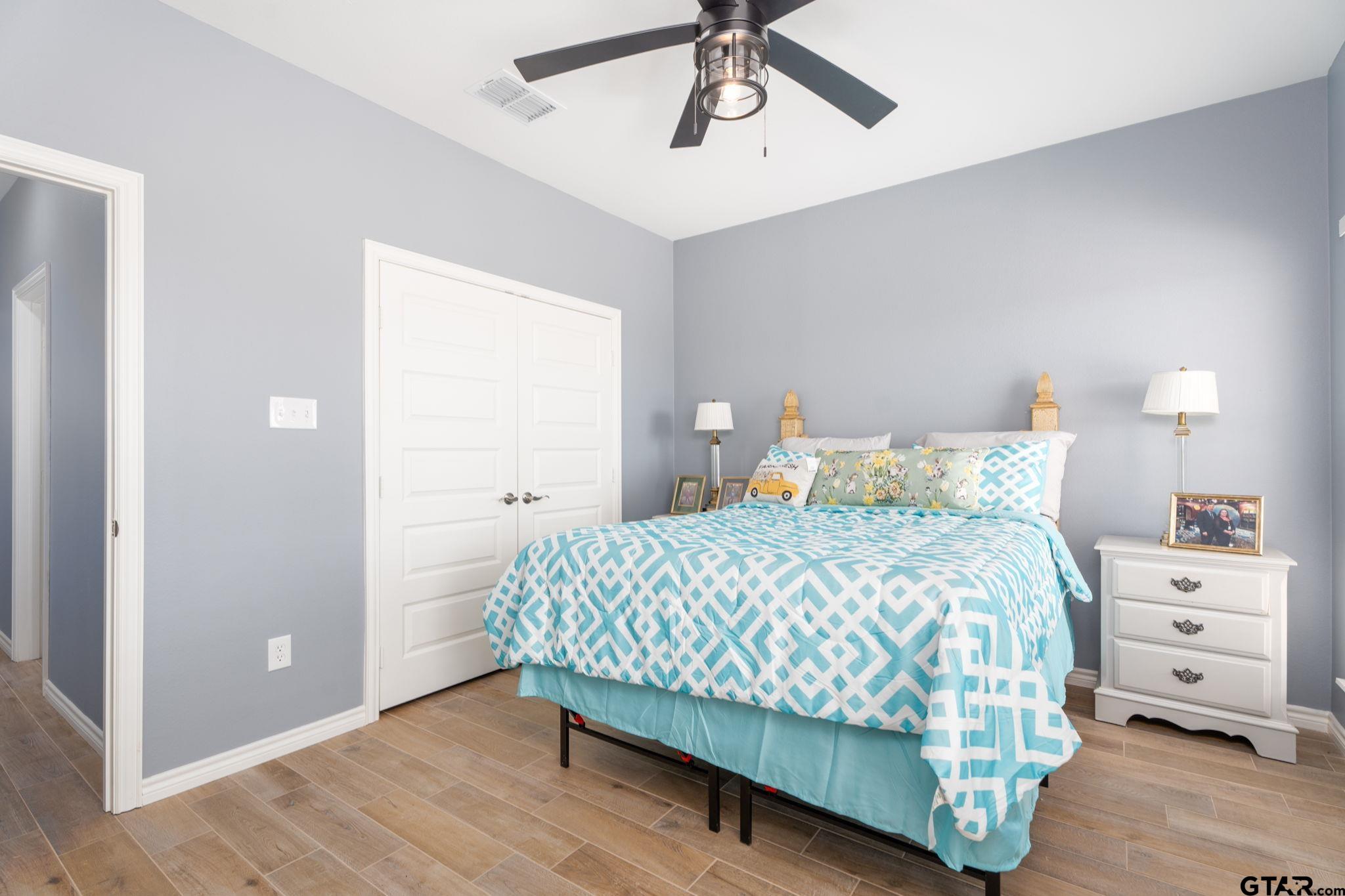 4356 Buie Road Diana, TX 75640 - Photo 19 of 29 a bedroom with a bed and a chandelier