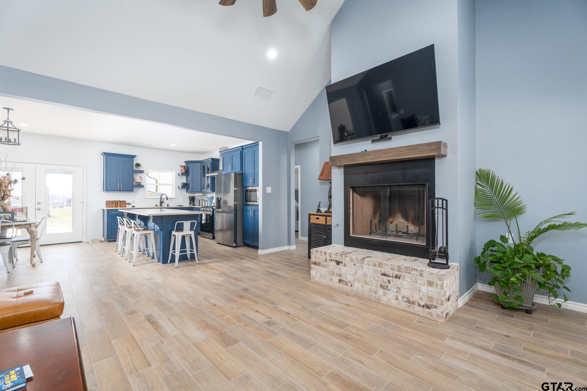 4356 Buie Road Diana, TX 75640 - Photo 4 of 29 a living room with furniture a fireplace and a flat screen tv