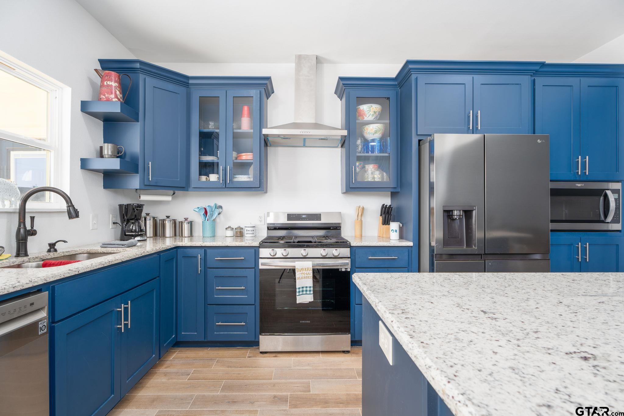 4356 Buie Road Diana, TX 75640 - Photo 8 of 29 a kitchen with stainless steel appliances granite countertop a stove top oven a sink and dishwasher