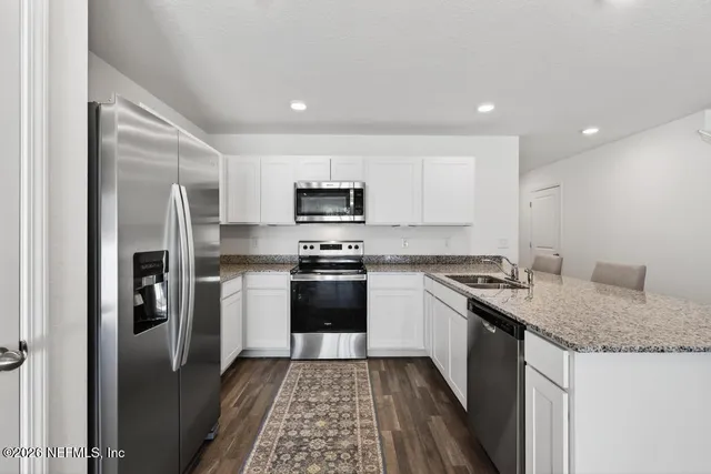 a kitchen with a sink stove and refrigerator